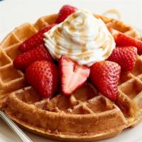 Belgian Waffle With Fruit · choice of fresh blueberries or strawberries heaped on a warm waffle, fresh whipped cream.