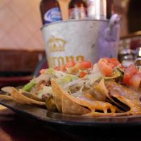Nachos · Homemade corn tortilla chips topped with beans, carne asada, and melted cheese.