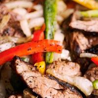 #15 Fajitas Plate · Marinated Steak or Chicken Breast Strips,  grilled with fresh bell peppers, onions and tomat...