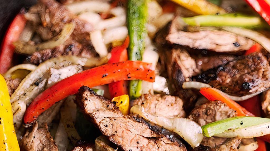 #15 Fajitas Plate · Marinated Steak or Chicken Breast Strips,  grilled with fresh bell peppers, onions and tomatoes. Served with guacamole, sour cream and 2 flour tortillas. Served with beans, rice, on the side.