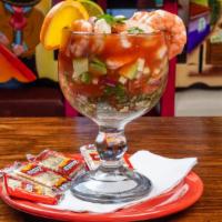 Mexican Shrimp Cocktail · A combination of shrimp, avocado, onions, tomatoes, cilantro, cucumbers in a traditional bro...