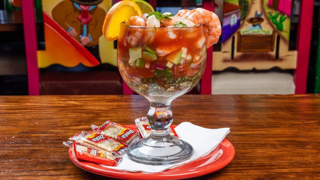Mexican Shrimp Cocktail · A combination of shrimp, avocado, onions, tomatoes, cilantro, cucumbers in a traditional broth. Served warm or cold.