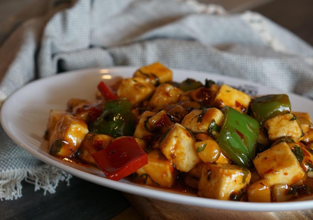Kung Pao Paneer · Gluten free. Spicy.  Cubed paneer, bell pepper, water chestnut, peanuts, dry red chili. Dry for $1 extra.