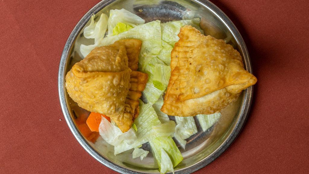 Samose · Triangular pies stuffed with potatoes and peas, delicately tempered with spices and herbs.