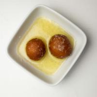 Gulab Jamun · Pastry balls served warm in cardamom and honey syrup. A very traditional dessert.