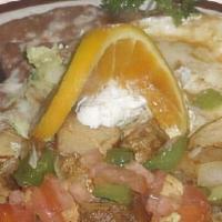 Huevos Rancheros · Two fried eggs in butter served with a corn tortilla and covered with ranchero sauce.