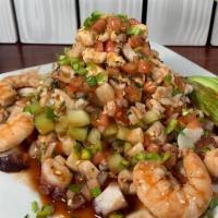 Tostada Extrema · Shrimp ceviche, fish ceviche, octopus, cooked shrimp, avocado and peppers.
