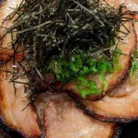 Chashu Bowl · Slices of grilled chashu pork served over rice with green onions,