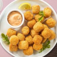 Potato Tots · Shredded Idaho potatoes formed into tots, battered, and fried until golden brown.