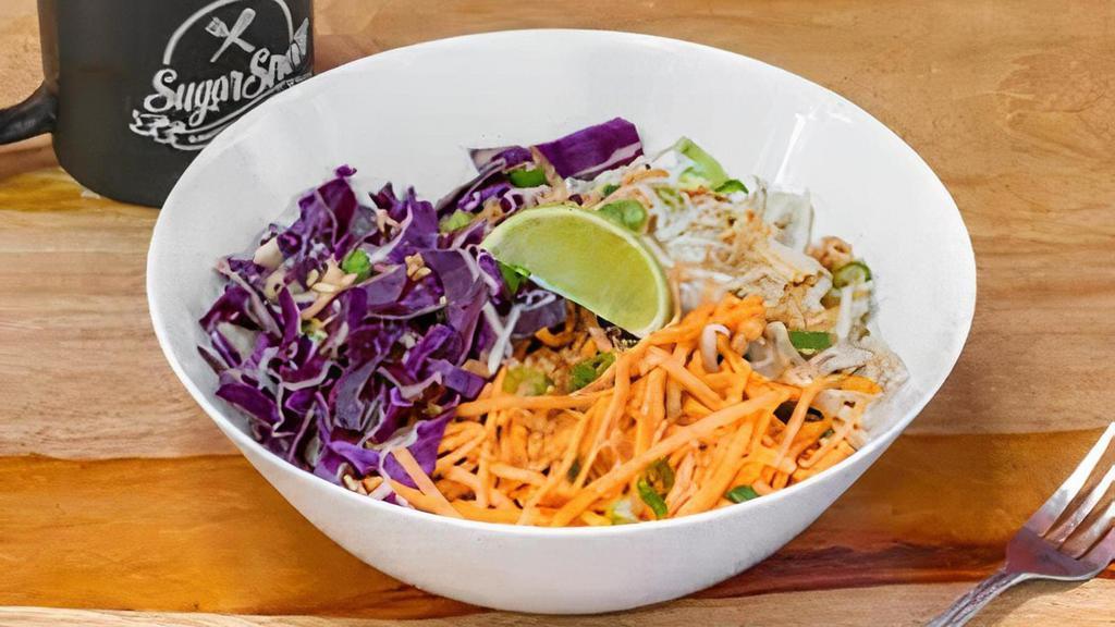 Thai Bowl · Thai sauce, rice, beans, shredded carrots, red cabbage, bean sprouts, lime wedge, topped with toasted coconut and green onions.