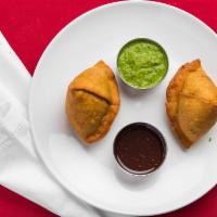 Vegetable Samosas (2) · Crispy patties stuffed with potatoes, peas and spices.