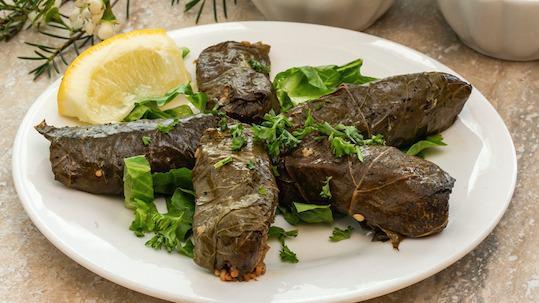 Vegetarian Dolma · Tender grape leaves stuffed with rice, parsley, lemon juice, & olive oil.