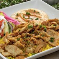 Chicken Shawarma Plate · Thinly sliced marinated and sautéed chicken served on a bed of basmati rice. Includes hummus...