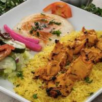 Chicken Kabob Plate · 2 skewers of grilled chicken breast served on a bed of basmati rice. Includes hummus and cho...