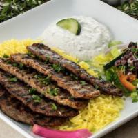 Gyro Plate · 5 strips of seasoned lamb and beef gyro served on a bed of basmati rice. Includes hummus and...