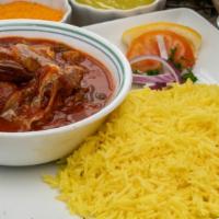 Okra And Lamb Stew · Tomato based stew with lamb and okra served on a bed of basmati rice. Includes hummus and ch...