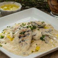 Chicken Marsala · Grilled chicken breast with mushrooms, garlic, and a creamy white sauce served on a bed of b...
