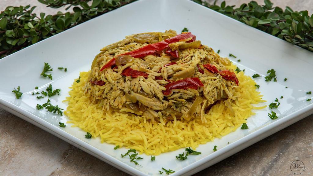 Maqluba Chicken · A shredded chicken breast, sautéed onion, bell pepper, eggplant, and potatoes served on a bed of basmati rice. Includes hummus and choice of salad.