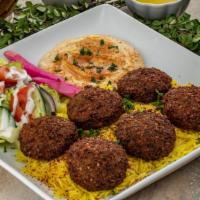 Falafel Plate · 6 pieces of fried seasoned chickpeas served on a bed of basmati rice. Includes hummus and ch...
