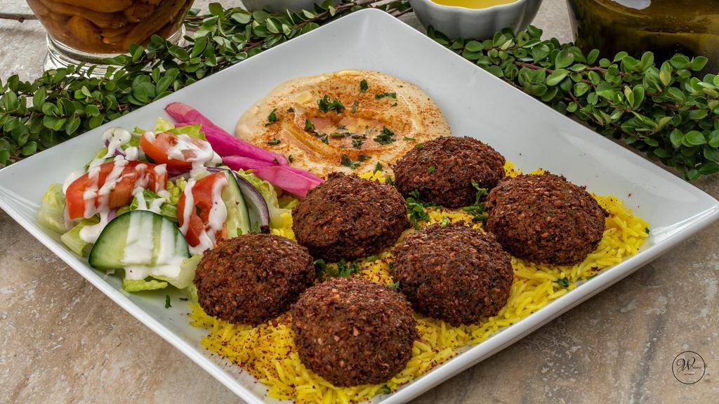 Falafel Plate · 6 pieces of fried seasoned chickpeas served on a bed of basmati rice. Includes hummus and choice of salad.