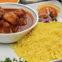 Chicken Curry · Chicken Curry in a tomato based stew with potatoes served on a bed of basmati rice. Includes...