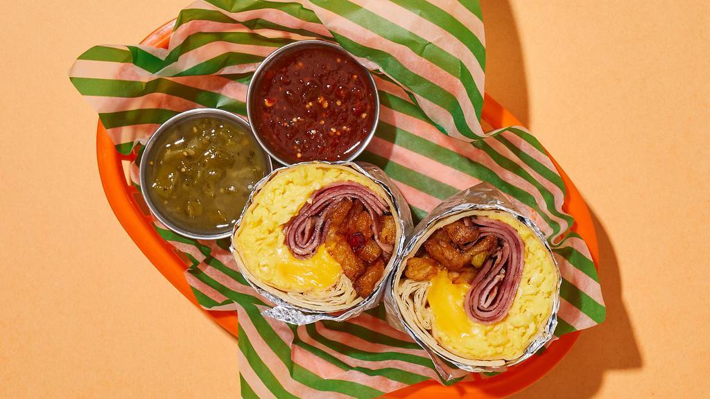 Hungry Ham Breakfast Burrito · Two scrambled eggs with savory ham, crispy potatoes, melted cheese, and caramelized onions wrapped up in a flour tortilla.