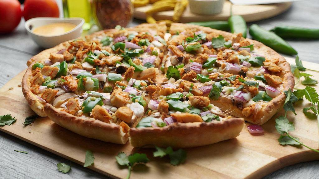 Halal Chicken Tikka Masala · This pizza has our signature tikka masala sauce, Halal Tikka Masala Chicken Breast, fresh diced mozzarella  cheese, fresh mushrooms, crisp red onions, fresh bell peppers, fresh diced; garlic, ginger, and green chilies, garnished  with fresh cilantro