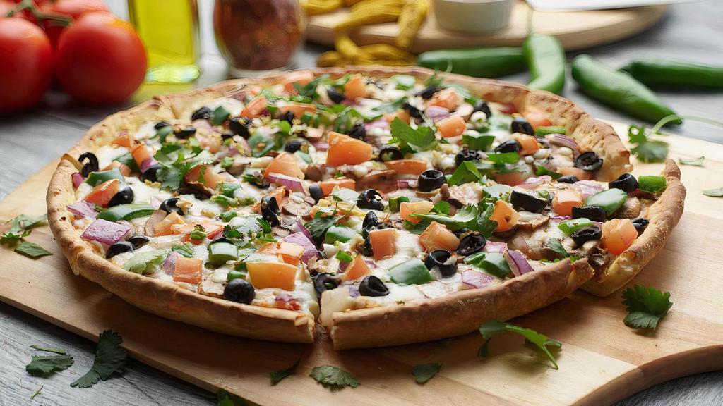 Indian Veggie Pizza Twist · This pizza has our signature red sauce, fresh mushroom, fresh green pepper, juicy tomatoes,  sliced black olives, crisp red onions fresh cut; garlic, ginger, and green chilies, garnished with fresh cilantro