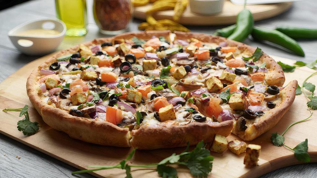 Curry Paneer Pizza Twist · This pizza has our signature curry sauce, masala paneer, fresh diced mozzarella cheese, fresh mushrooms, crisp red  onions, sliced black olives, juicy tomatoes, fresh cut; garlic, ginger, and green chilies, garnished with fresh cilantro.