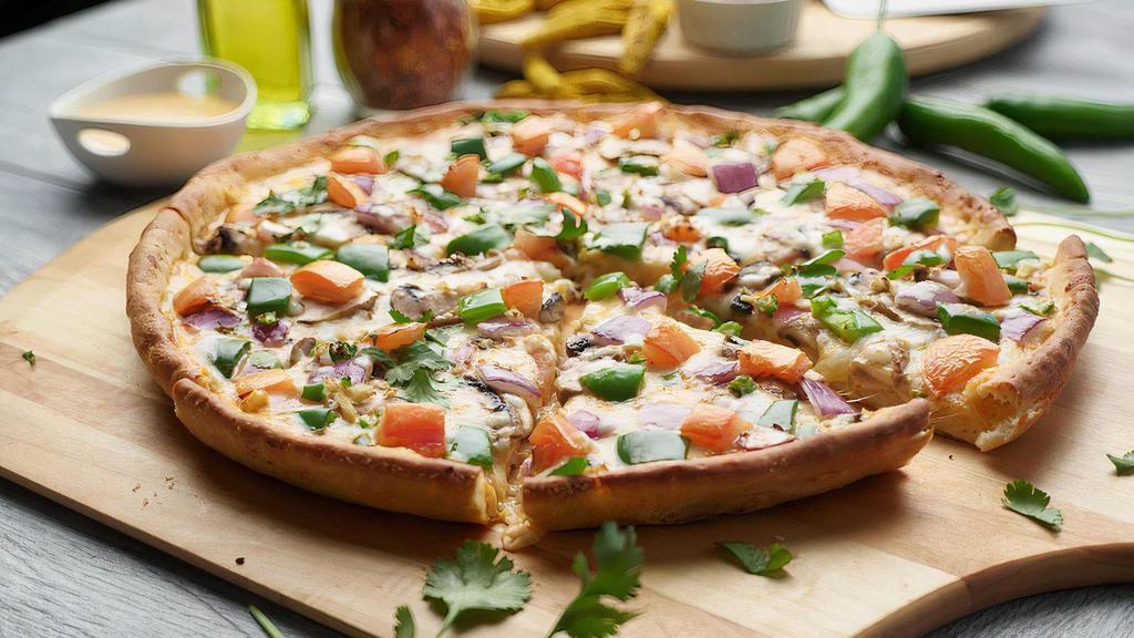 Tikka Masala Veggie Pizza Twist · This pizza has our signature tikka sauce, fresh diced mozzarella cheese, fresh mushrooms, crisp red  onions, fresh bell peppers, juicy tomatoes, fresh cut; garlic, ginger, and green chilies, garnished with fresh  cilantro