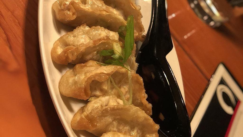 Chicken Gyoza · Six Japanese pot stickers! Little fried wrappers are filled with chicken and veggies, and dipped into a tasty sauce.
