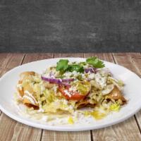 Flautas De Pollo · 4 Chicken rolled tacos, served with lettuce, red onion, and queso fresco topped in house-mad...