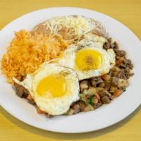 #21 Steak Ranchero Plate · Two sunny side-up eggs with steak, pico de gallo, and enchilada sauce on a plate with rice a...