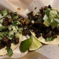 Asada Taco · Tender grilled marinated steak. Diced onion and cilantro. Served on two hot corn tortillas.