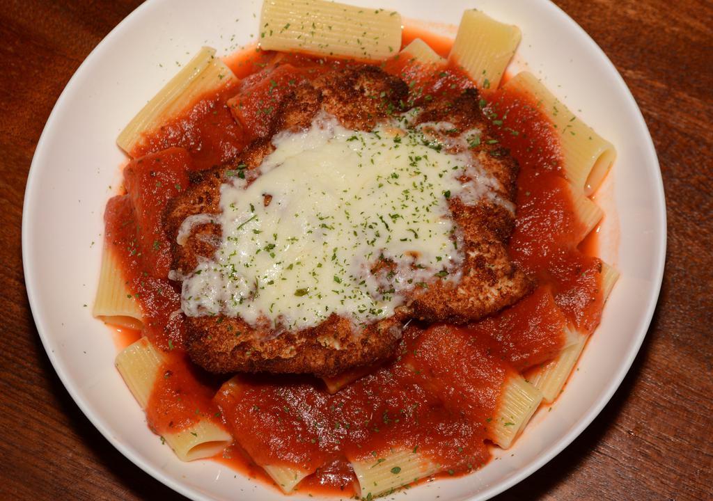 Chicken Parmigiana · Chicken parmigiana served with pasta topped with marinara and mozzarella, served with crostini.