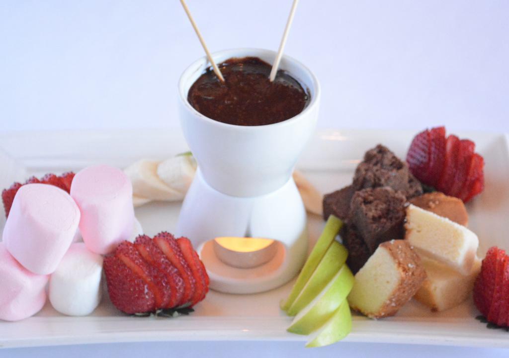 Fondue For Two · Chocolate Fondue with pound cake, fresh fruit, marshmallows , and brownie, bites.