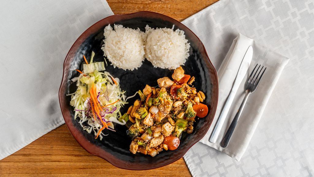 Kung Pao Chicken · Tender chicken, sauteed with veggies in spicy sauce and peanuts. Served with rice and salad.
