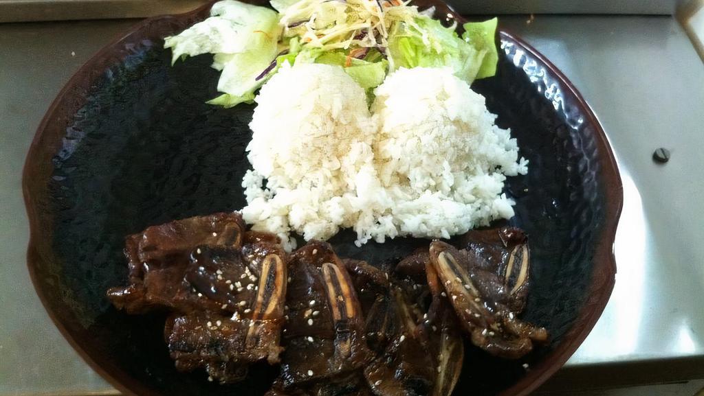 Korean Beef Short Ribs · Korean style beef short ribs marinated, grilled. Served with rice and salad.