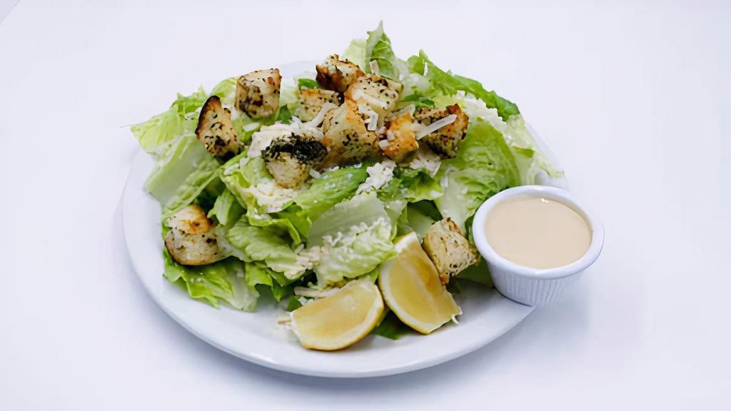 Caesar Salad · Crisp Romaine lettuce, shredded Grana Padano & house made croutons, tossed in our creamy Caesar dressing.