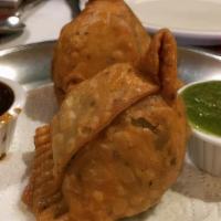 Lamb Samosa · Minced lamb, spinach, green peas and spices wrapped in homemade pastry dough and deep fried.