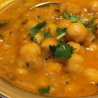 Chana Masala · Garbanzo beans cooked with ginger, garlic, tomato, and spices.