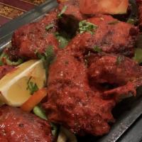 Chicken Tandoori · Marinated Chicken leg quarter in nepali sauces and barbecued in tandoori oven ( serve with f...