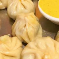 Chicken Momo · Steamed chicken dumpling mildly spiced with ginger, garlic, onion, and spices.