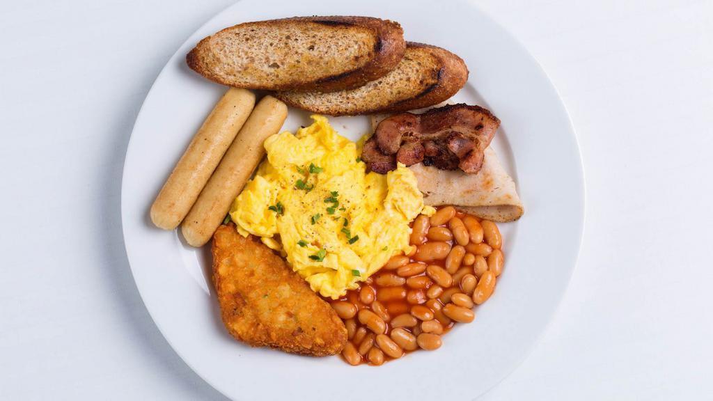 Tofu Scramble Big Breakfast · Delicious Vegan Breakfast dish of Tofu scramble, served with bacon, sausage, hash browns, and a buttered, toasted english muffin.