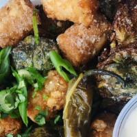  Brussel Tots · Brussel sprouts, tater tots, & sliced jalapeños fried and tossed in grated Parmesan. Served ...