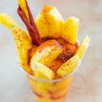 Mangonada · Nieve de mango, chamoy, Tajín. / Mango ice cream, chamoy and Tajín.