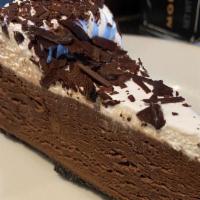 Chocolate Cake · A slice of chocolate mousse cake with vanilla foam icing and chocolate shavings.
