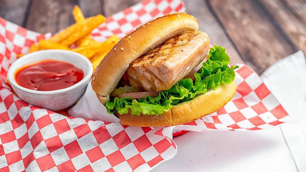 Salmon Burger · Grilled salmon, lettuce, tomato, red onion, pickles, and house sauce. Served with French fries.