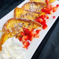 The Golden French Toast · Two thick taxes toast, strawberries (seasonal), whipped cream, powder sugar, maple syrup.