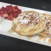 The Flour Tower · Two pancakes, strawberries (seasonal), maple syrup, powdered sugar, butter.